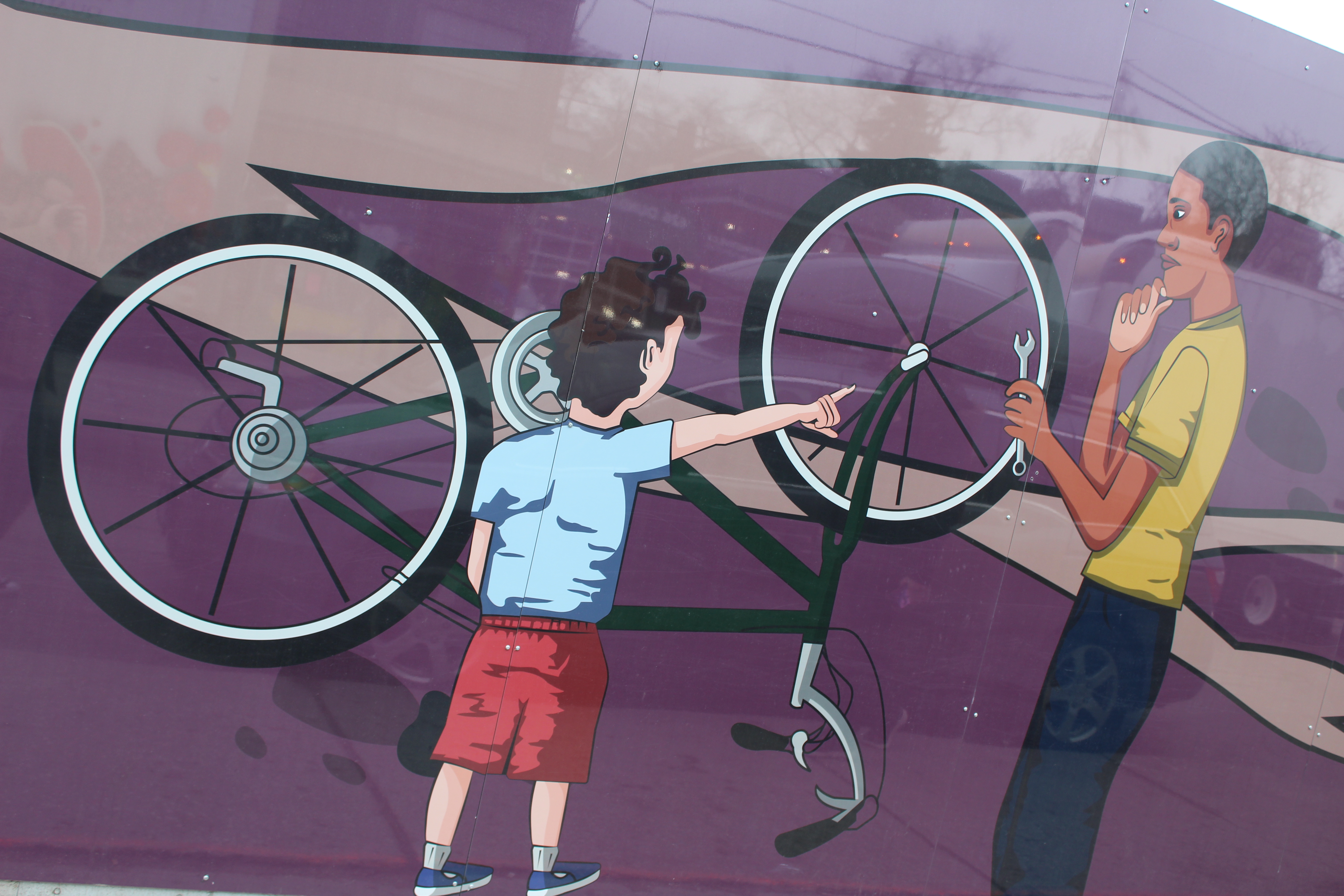 mural illustration of a youth fixing a bicycle