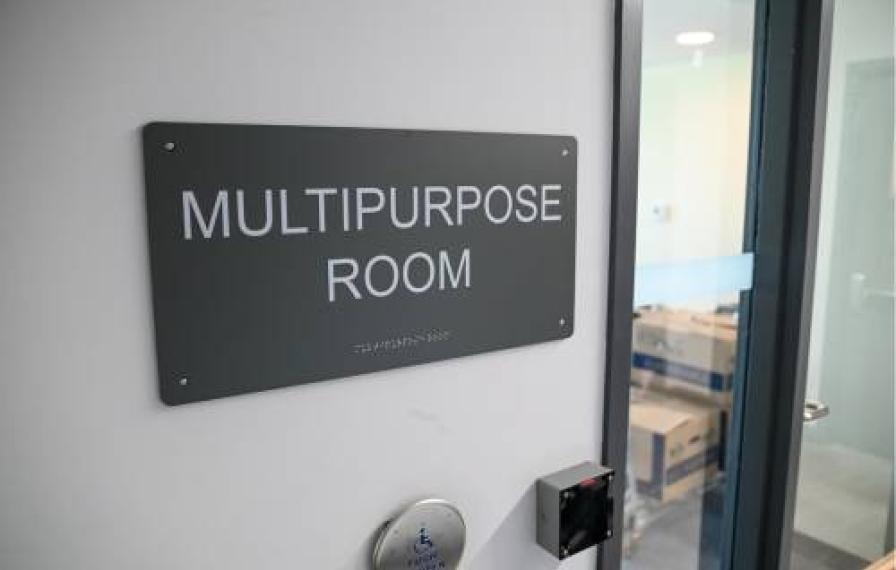 A sign near a door that says Multipurpose Room
