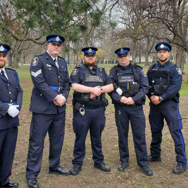 Six male special constables standing in a row posing for the camera in their uniforms. 