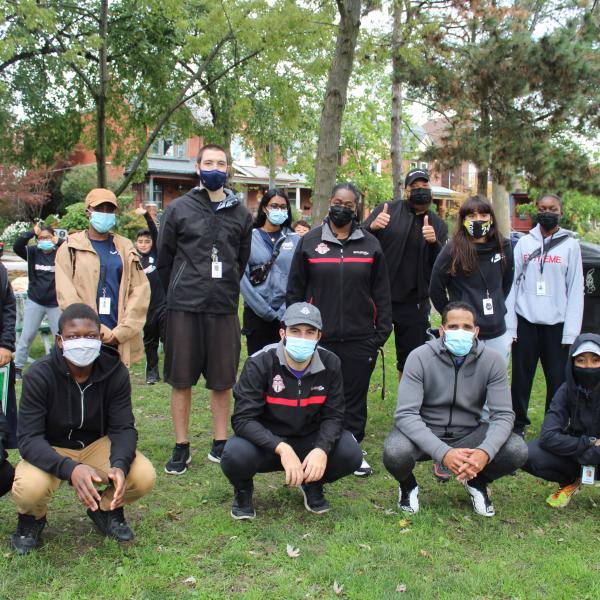 Group photo of TCHC and KickStart staff outdoors in the park wearing masks