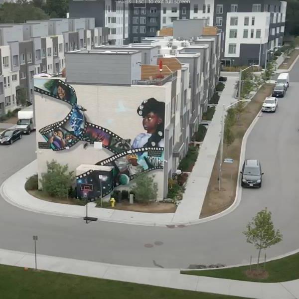 Aerial view of Leslie Nymark community displaying mural on side of townhomes.