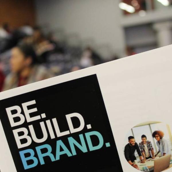 Close up of the program for the 2018 Be. Build. Brand. pitch contest.