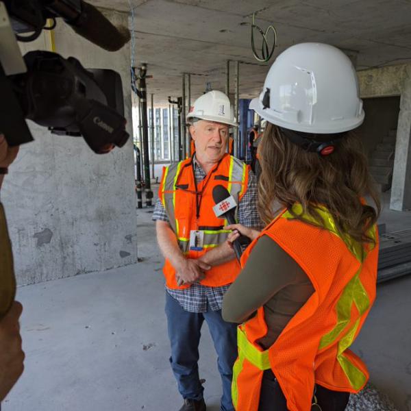 TCHC’s Senior Director of Development, Peter Zimmerman, speaks to a reporter about the latest building in the revitalization project, 16N, the transformation of Regent Park to date and where the project is headed with the next and final phases, Phases 4 and 5.