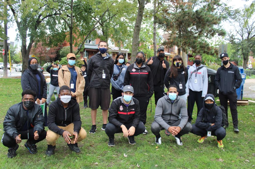 Group photo of TCHC and KickStart staff outdoors in the park wearing masks
