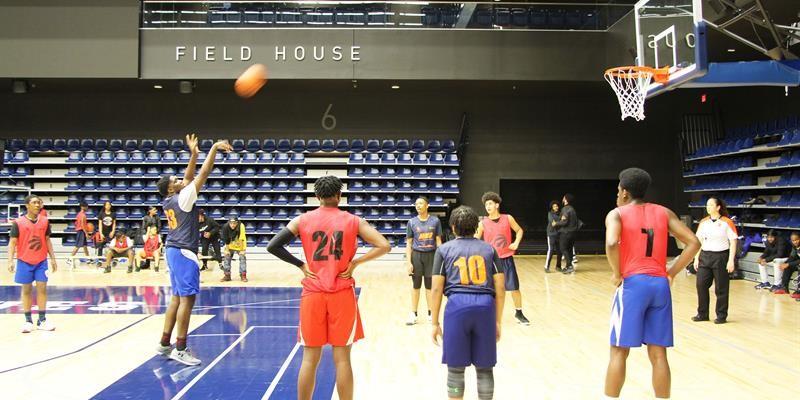 Tenant youth playing basketball on an indoor court