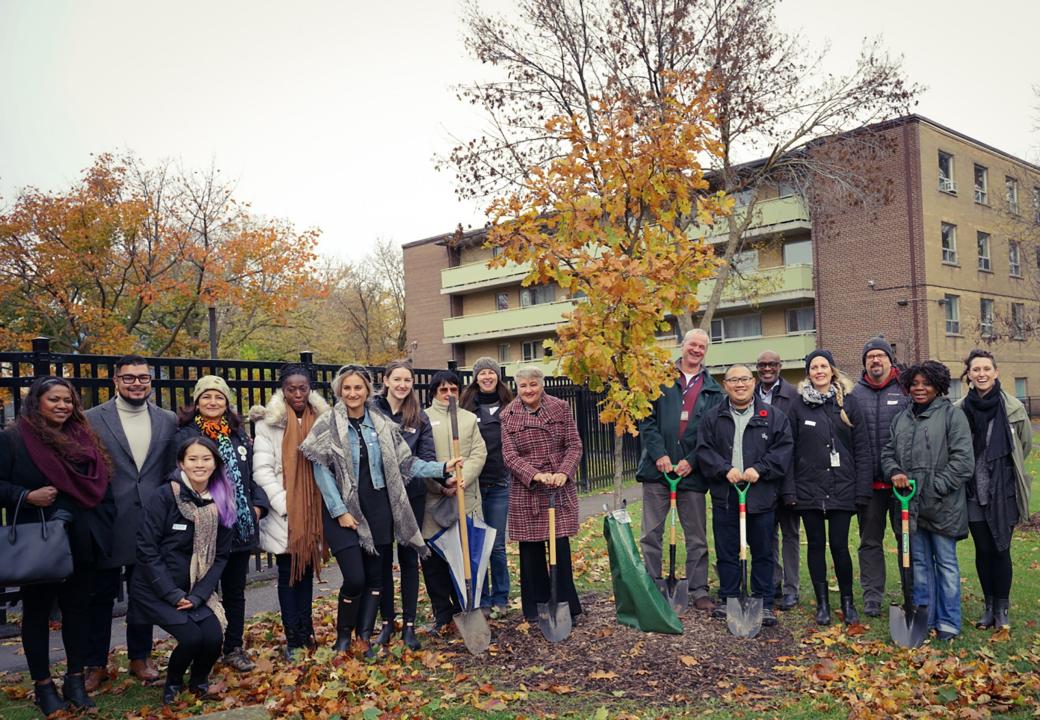 Photo of Tenants, TCHC and LEAF staff, partners, and guests outdoors in front of trees