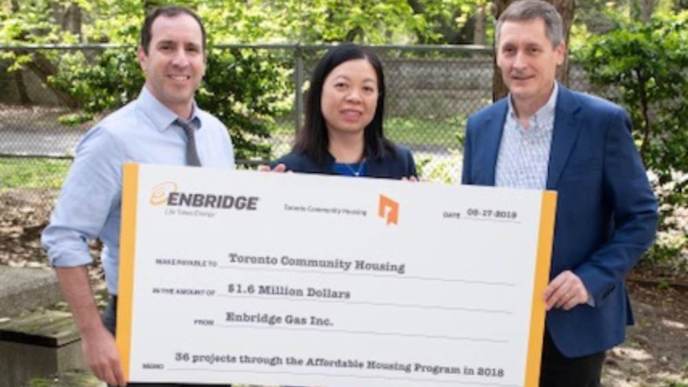 Ward 12 Councillor Josh Matlow, Rose-Ann Lee, Chief Financial Officer of Toronto Community Housing, and Jim Sanders, Senior Vice President, Enbridge Gas, during Enbridge's $1.6 million incentive cheque presentation to Toronto Community Housing for the completion of 36 energy efficiency projects at buildings across Toronto in 2018. 
