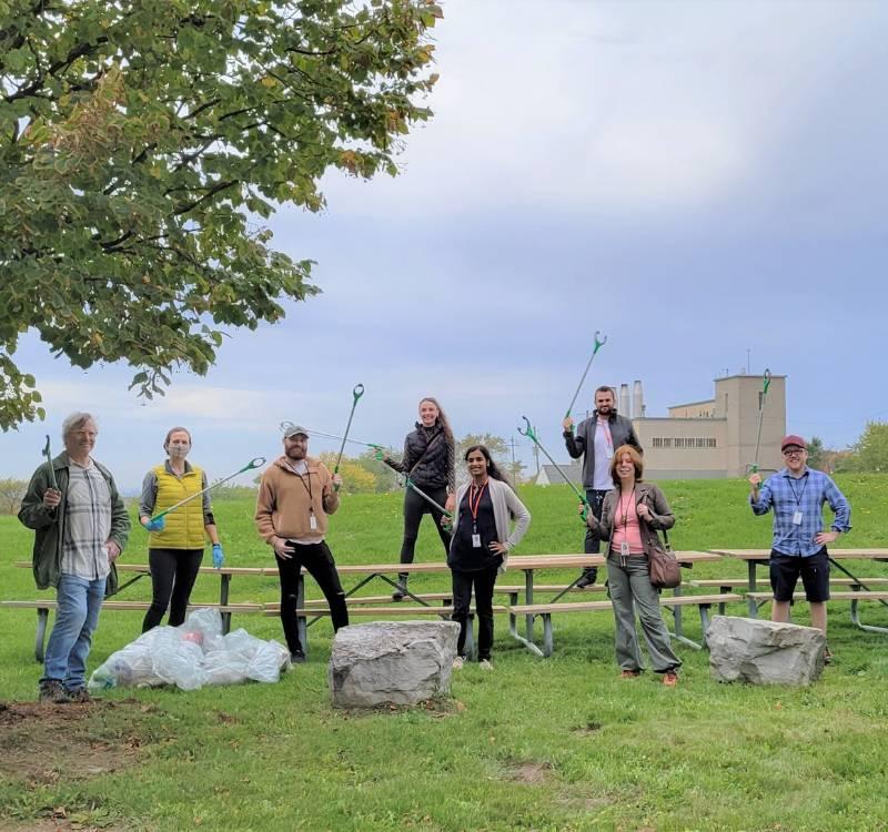 Conservation team members in a park holding litter pickers
