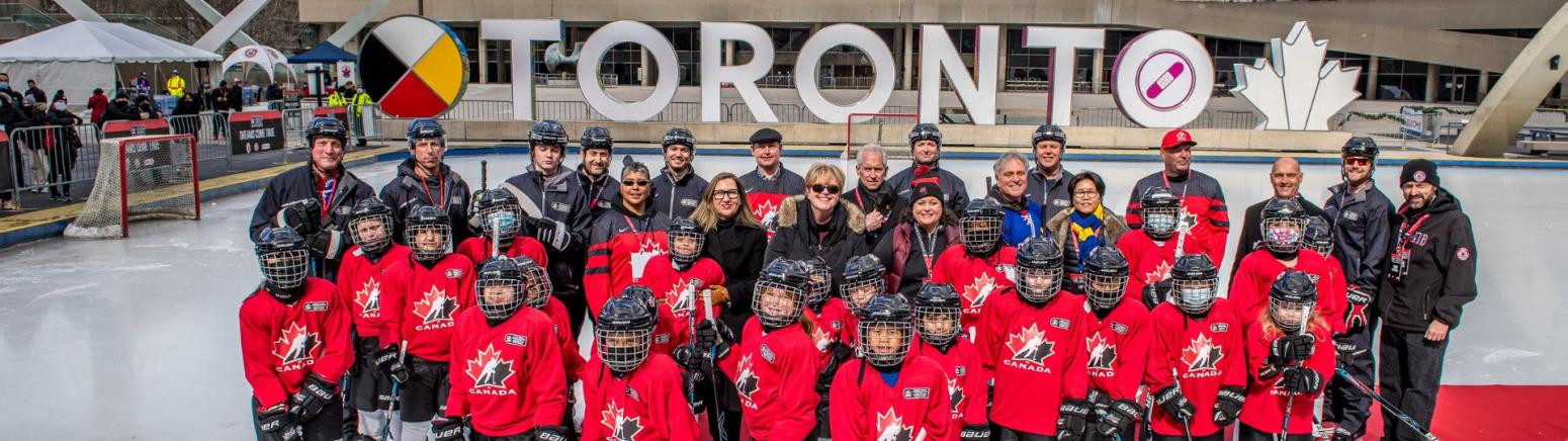 Hockey team in front of the Toronto sign