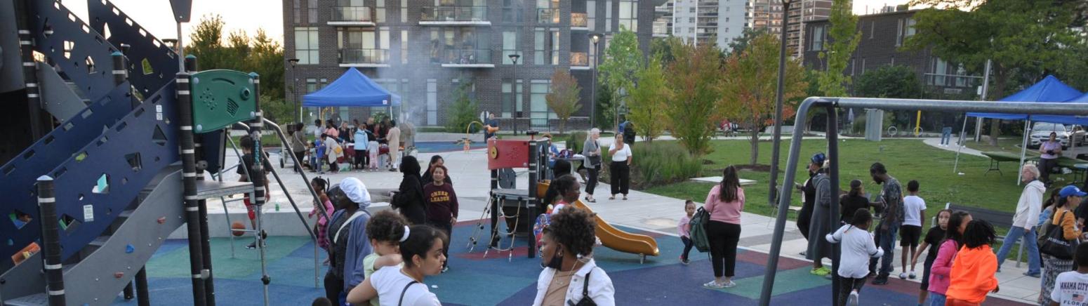 Members of the Allenbury Gardens community gather in the playground area for a bbq party to celebrate the end of the revitalization.